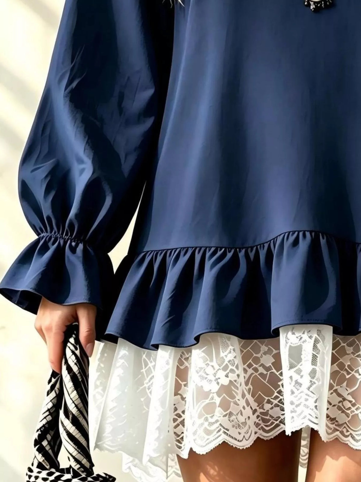 Dark blue long-sleeve mini dress with lace ruffle hem and gathered puff cuffs