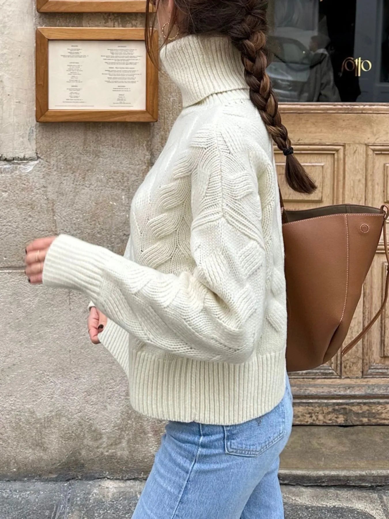 White long-sleeve turtleneck sweater with ribbed hem and chevron cable knit