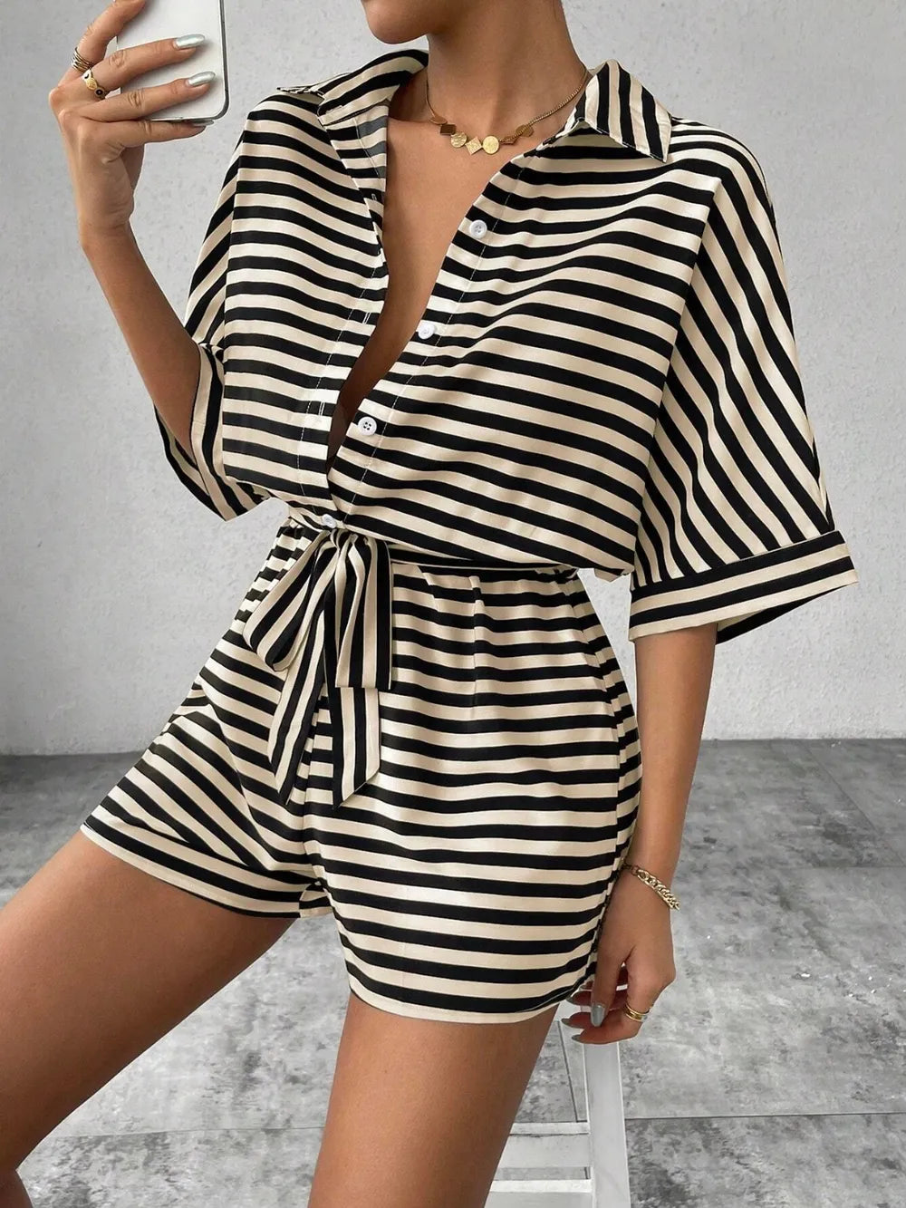 Striped tie-waist romper with V-neck and half-button front, short sleeves, black/white