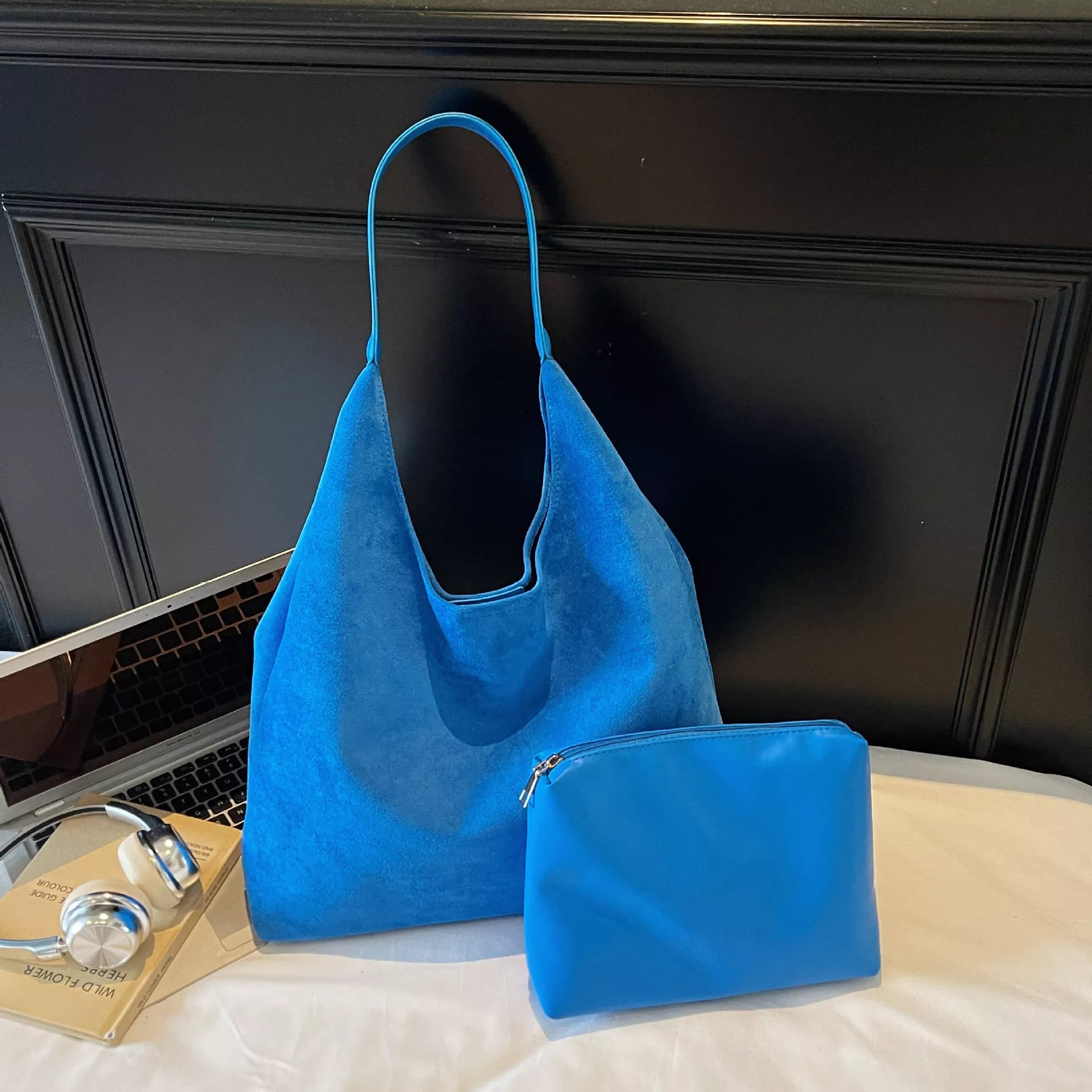 Blue shoulder bag with wide handle and matching small zip pouch