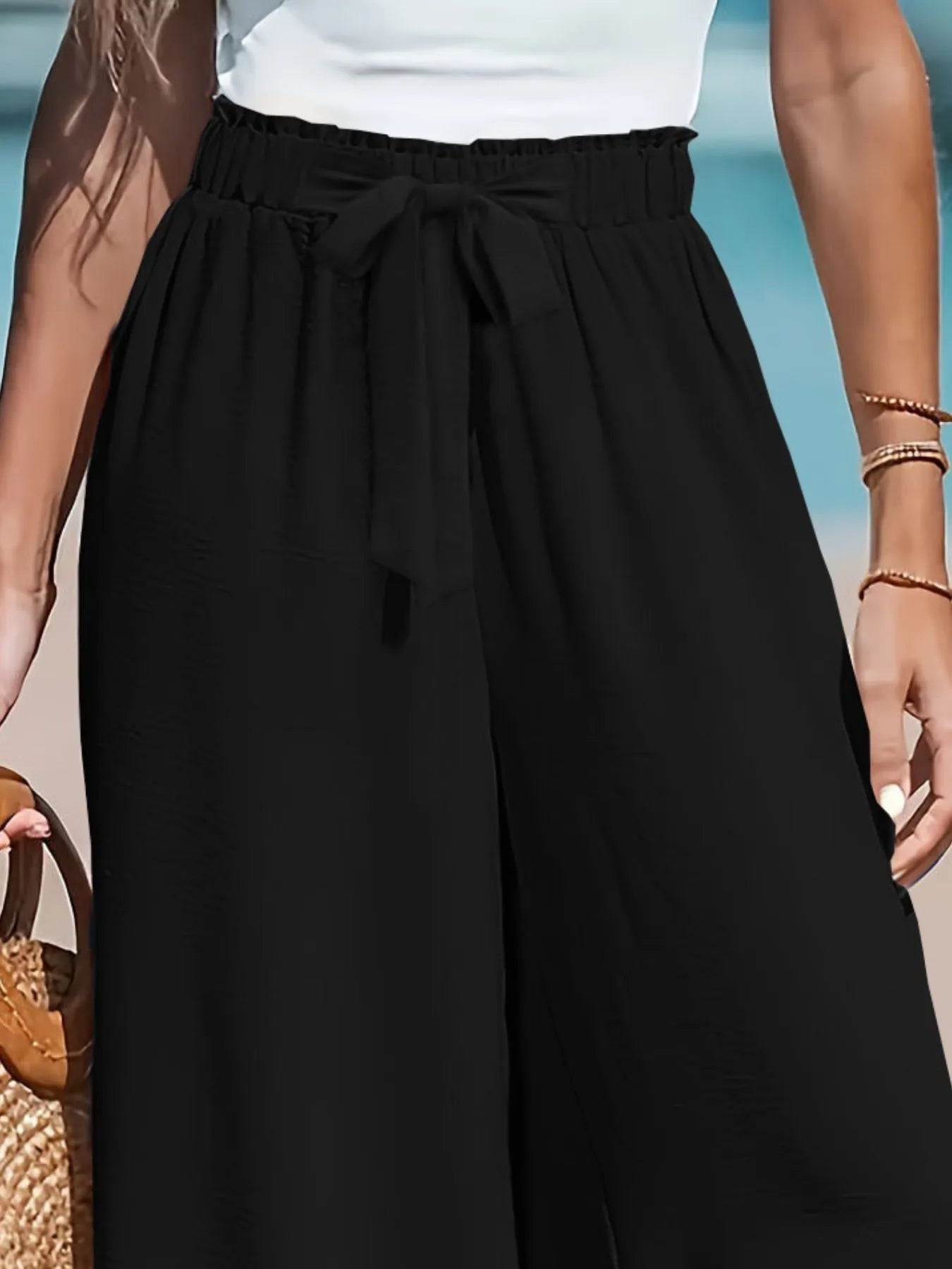 Black wide-leg drawstring pants with ruched waist and long flowy legs