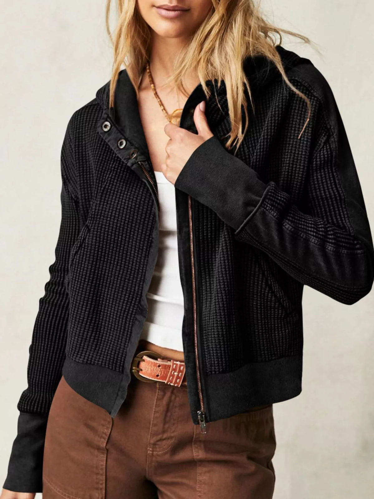 Black waffle knit zip-up jacket with hood and long sleeves