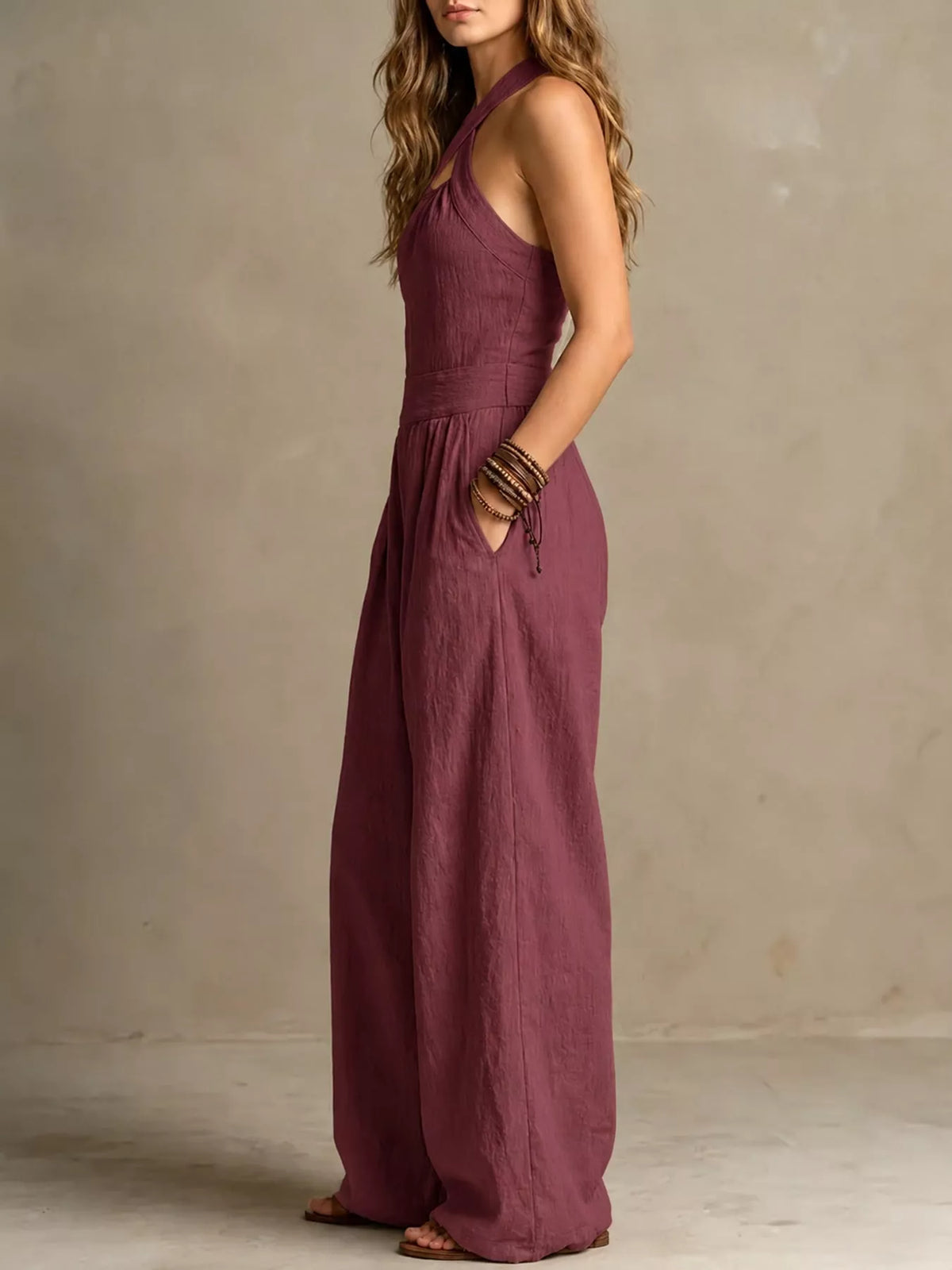 Burgundy halter linen jumpsuit with high waist and wide-leg wide skirted bodice