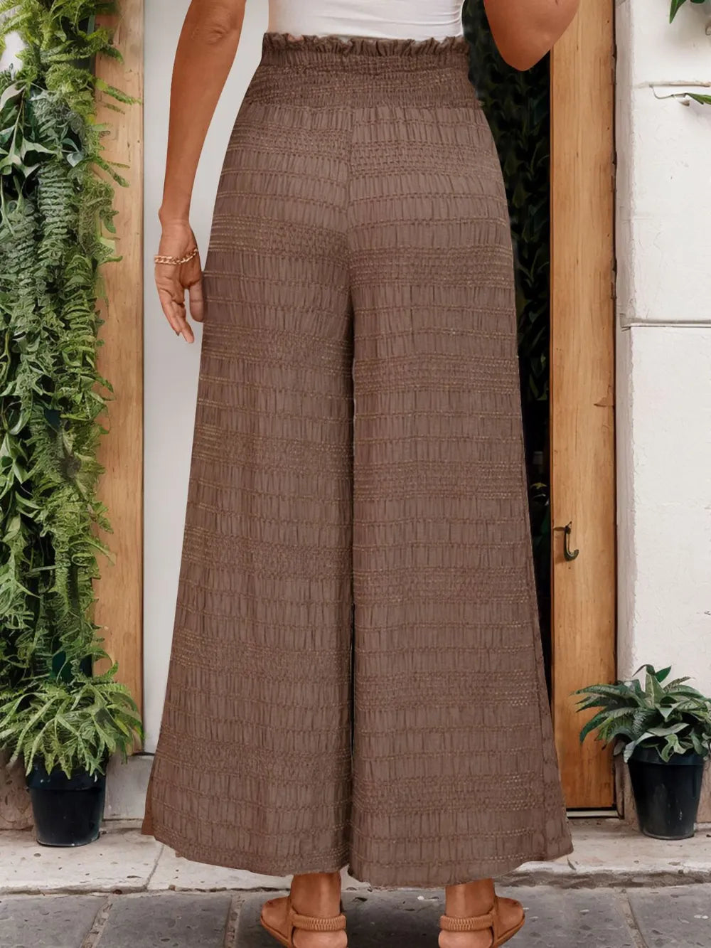 Brown wide-leg pants with elastic waistband and drawstring, textured weave