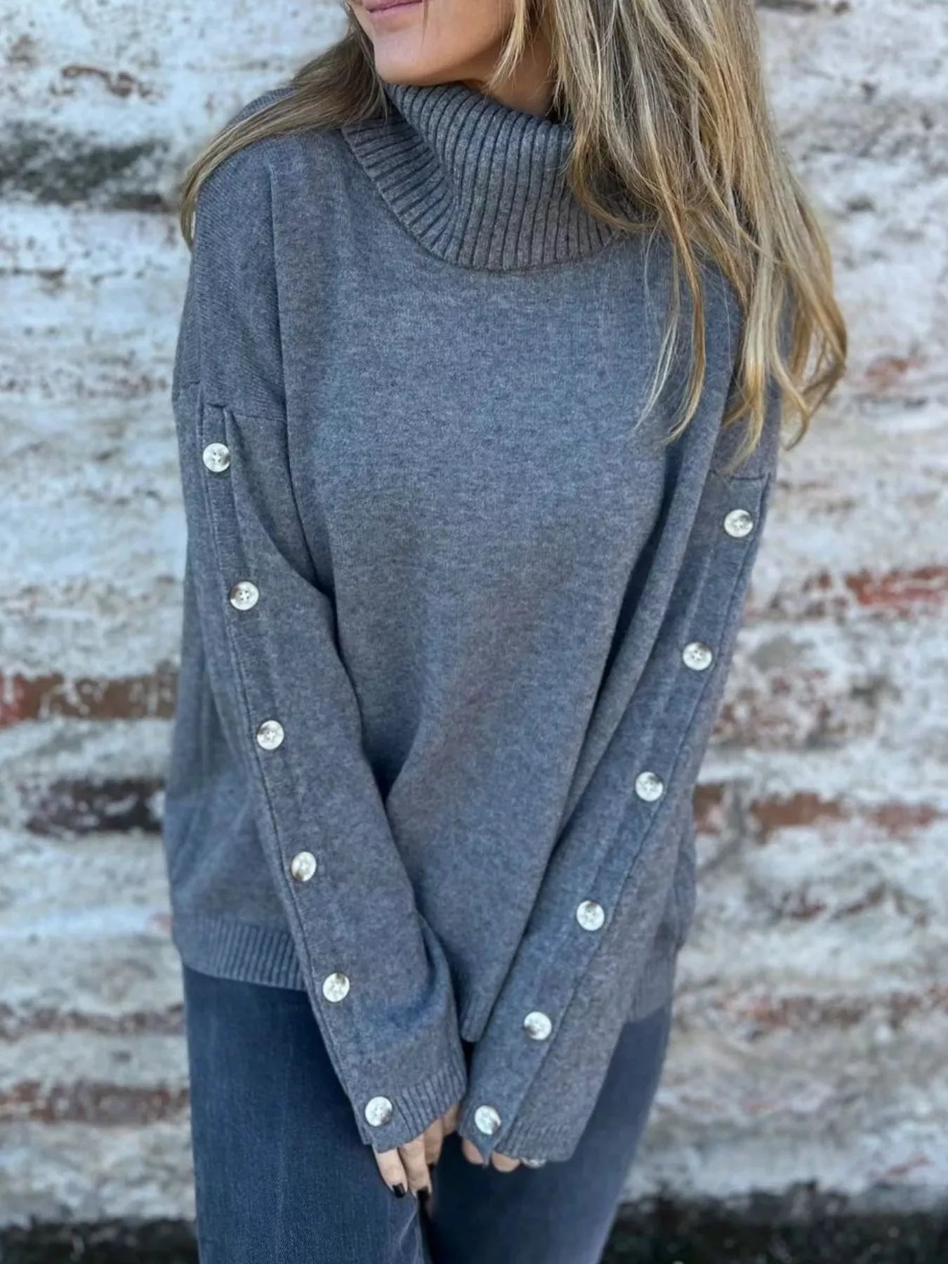 Heather gray turtleneck sweater with ribbed collar and buttoned long sleeves