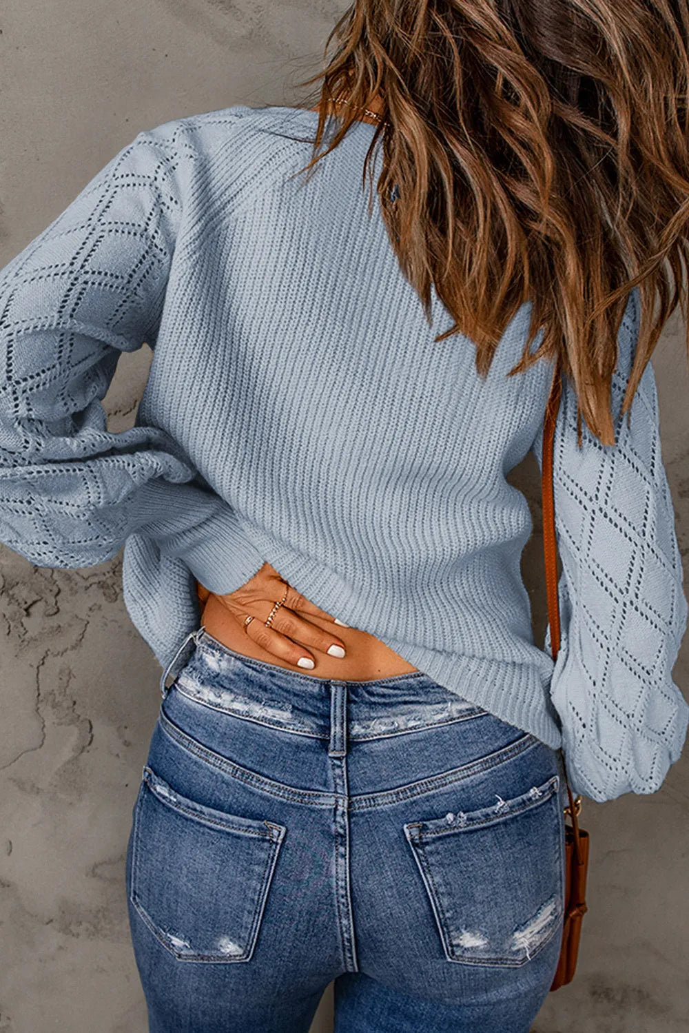 Light blue V-neck button-up sweater with openwork sleeve panels and ribbed hem
