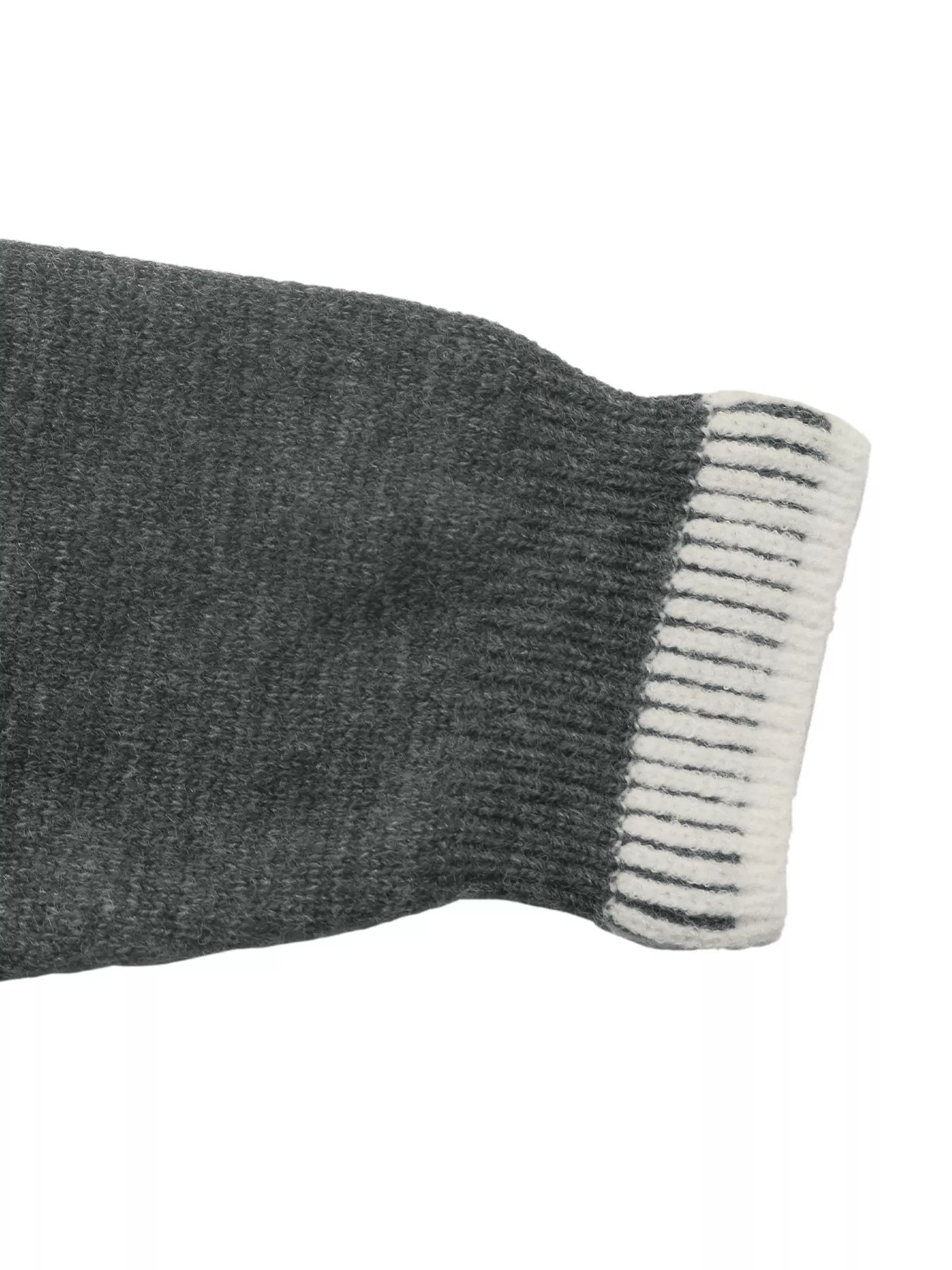 Dark gray sweater sleeve cuff with white ribbed striped trim