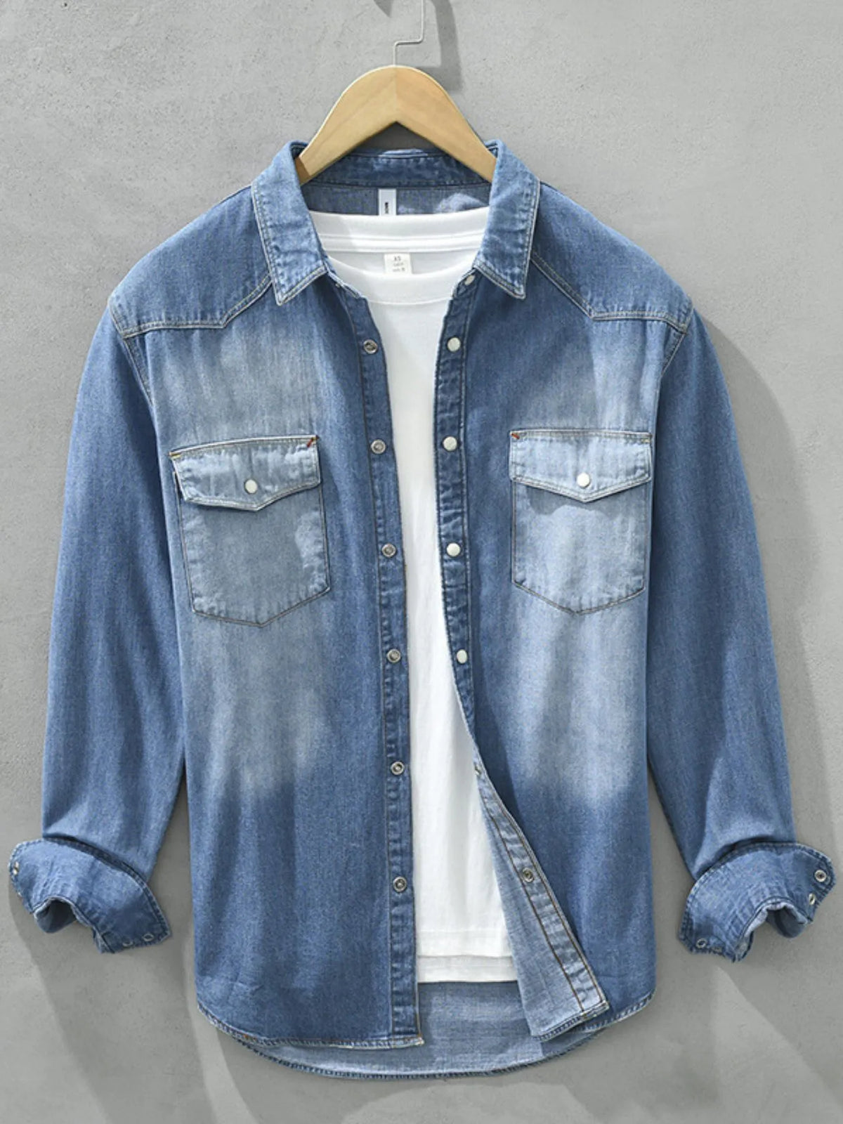 Men's washed denim button-up shirt with chest pockets, long sleeves, light blue