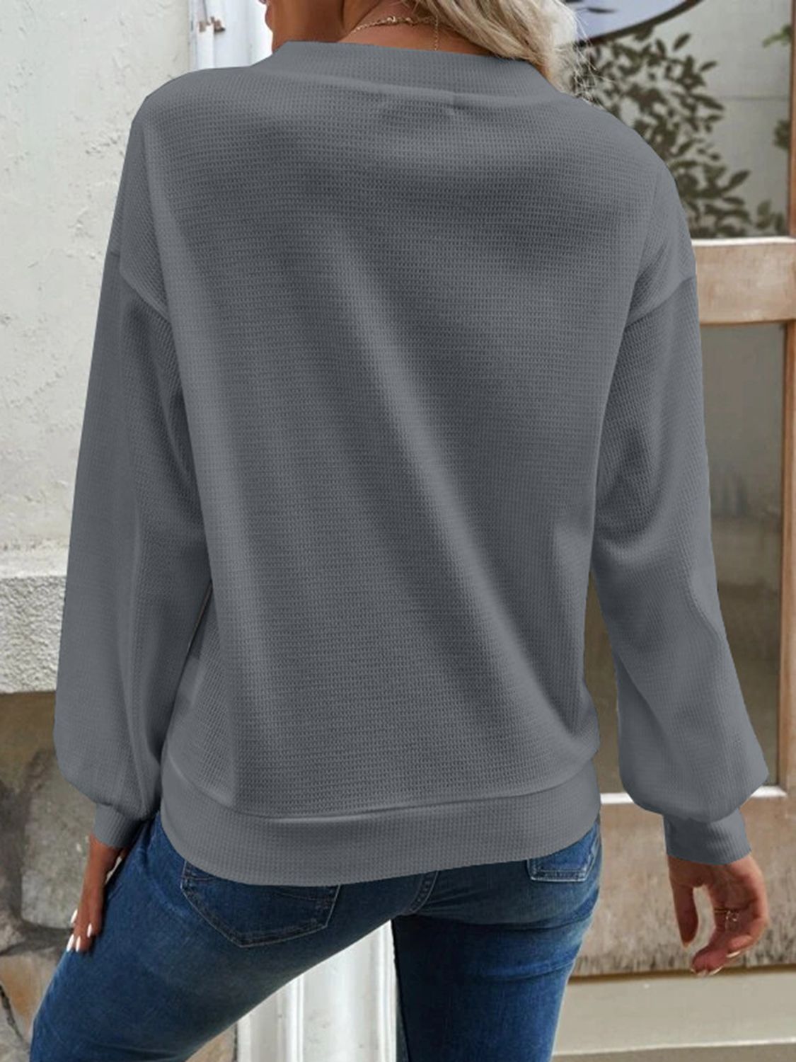 Dark gray blouse with V-neck, dropped shoulders, long sleeves, back view