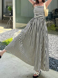 Ruched sleeveless maxi dress with black-and-white vertical stripes and thin spaghetti straps