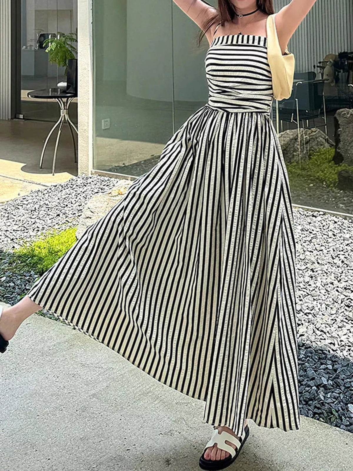 Ruched sleeveless maxi dress with black-and-white vertical stripes and thin spaghetti straps