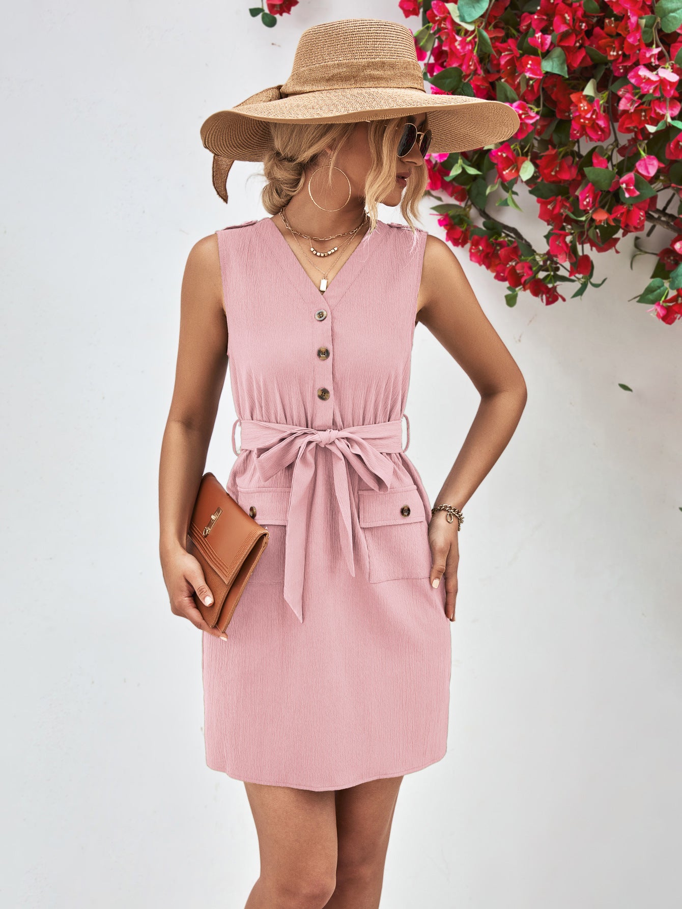 Blush pink sleeveless V-neck button dress with tied waist belt and flap pockets