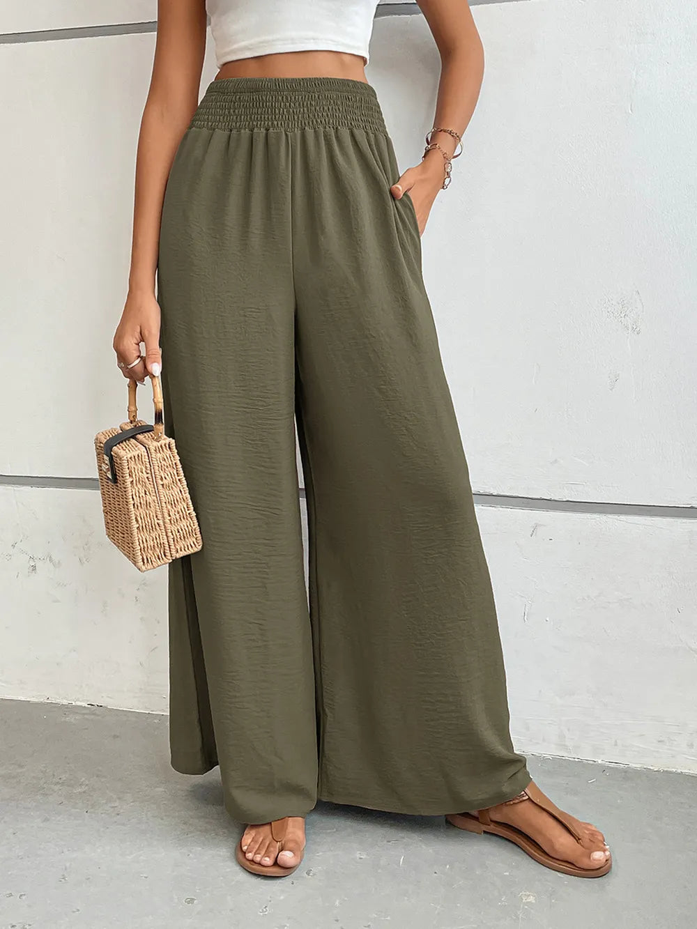 Wide-leg pants in olive green with elastic waistband and full drape wide legs