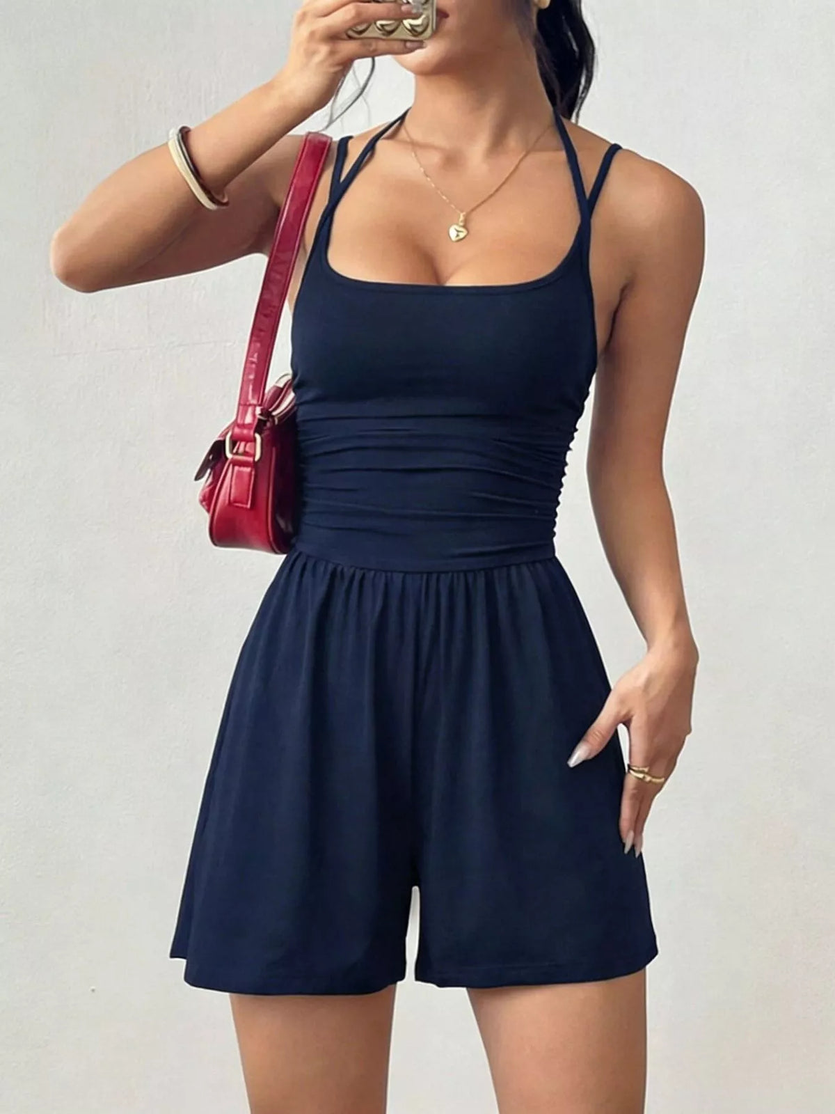 Navy ruched spaghetti-strap romper with square neckline and gathered short legs