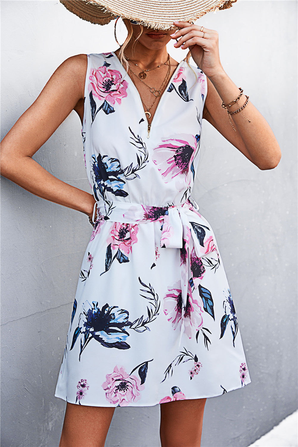 White sleeveless dress with floral print, V-neck, tied waist and front zip detail