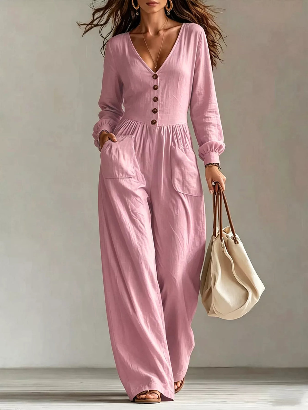 Dusty pink V-neck long-sleeve button-front jumpsuit with wide legs and front pockets