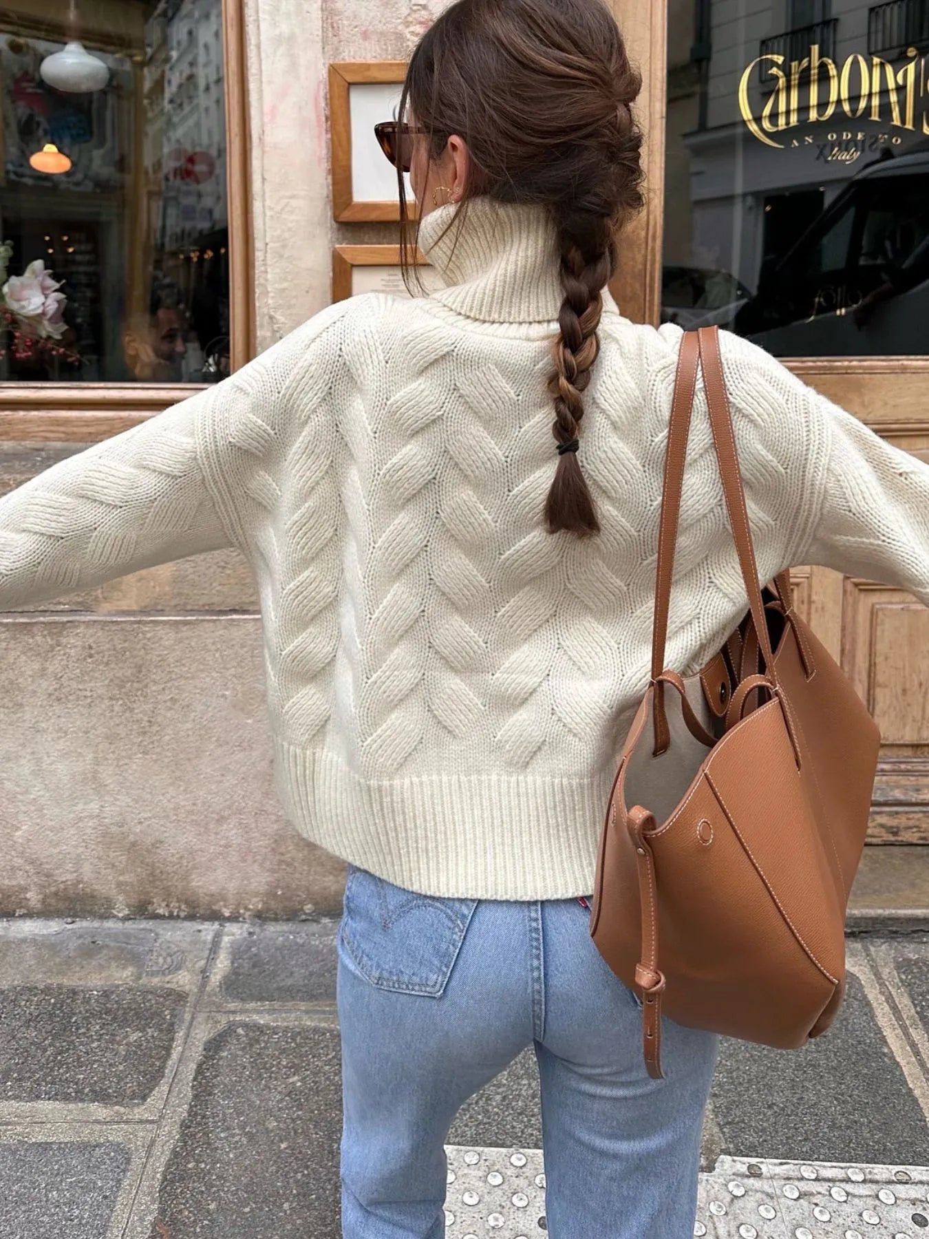 White turtleneck knit sweater with ribbed trim and chevron stitch pattern