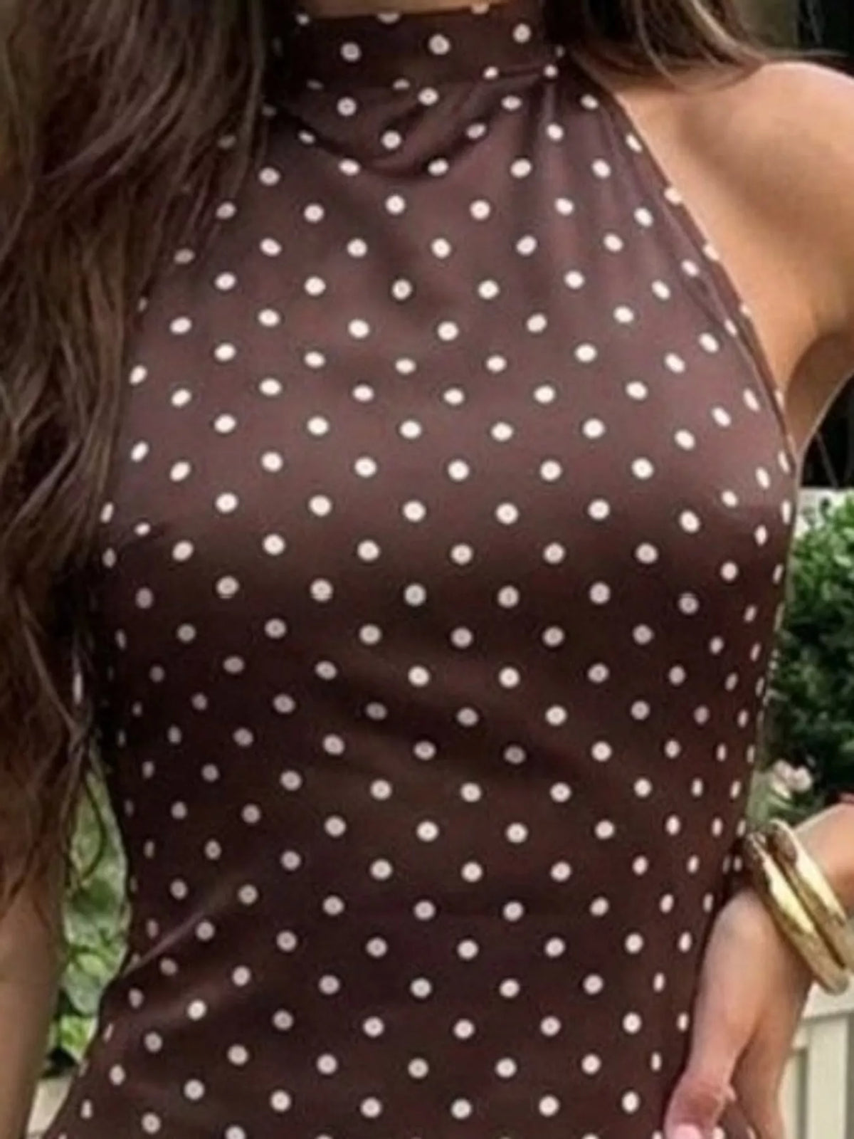 Brown polka-dot halter mini dress detail with high neckline and open back