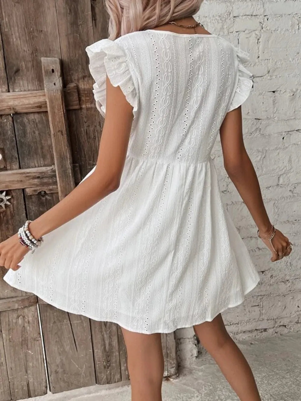 White eyelet mini dress with ruffled cap sleeves and back yoke detail
