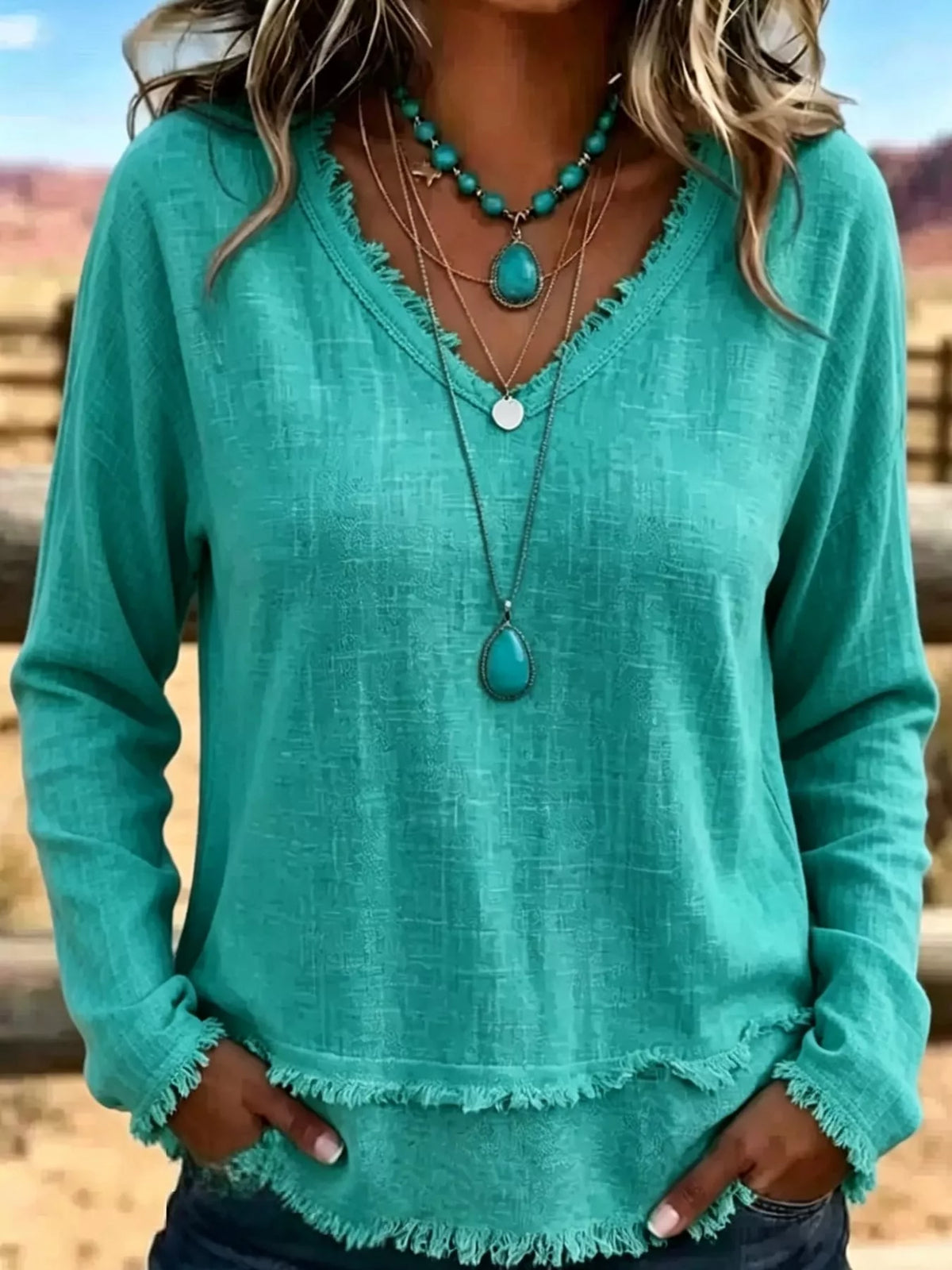 Teal linen-blend V-neck relaxed blouse with frayed hem and cuffs