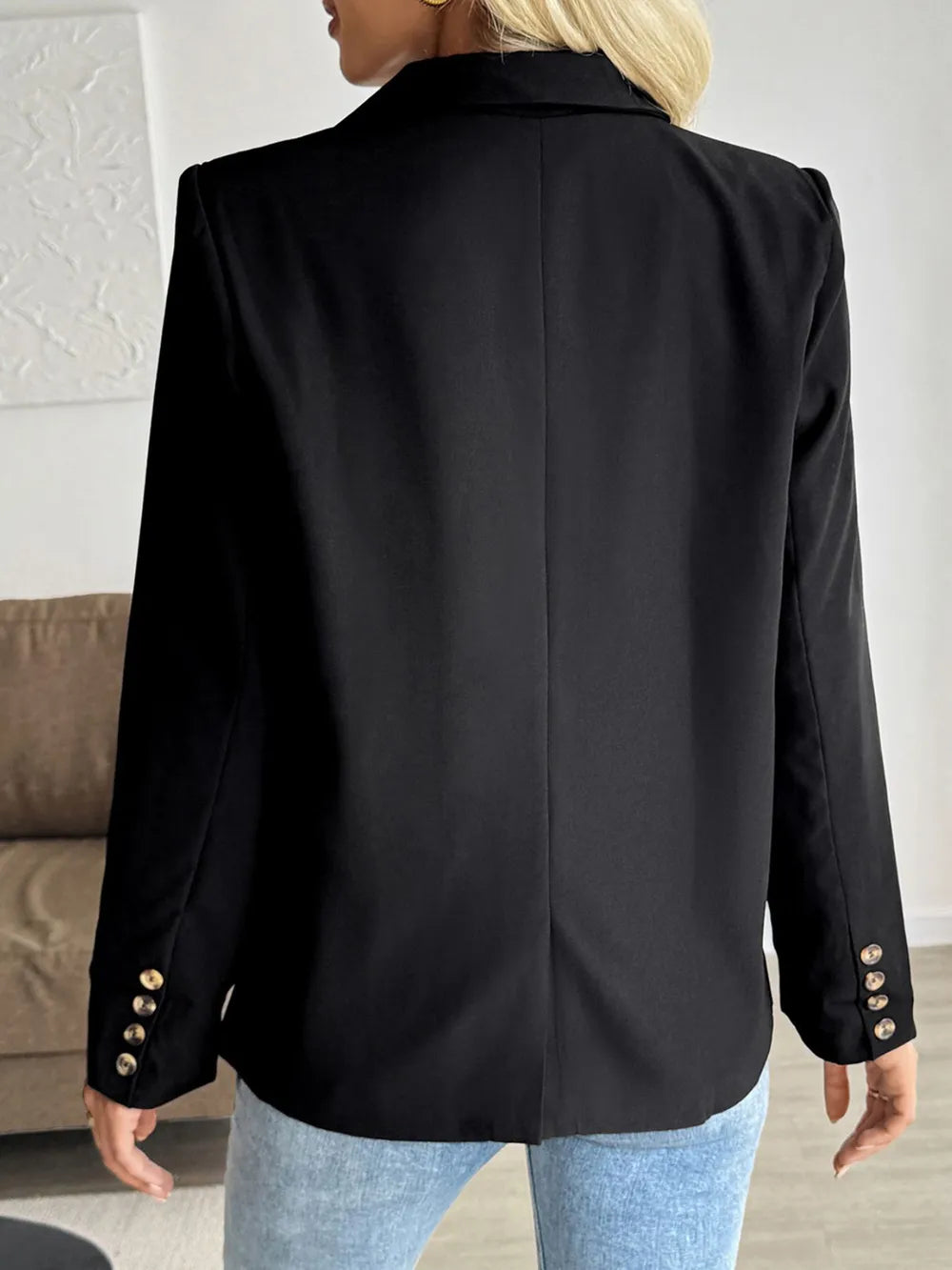 Black blazer back view with shoulder yoke and two-button cuffs