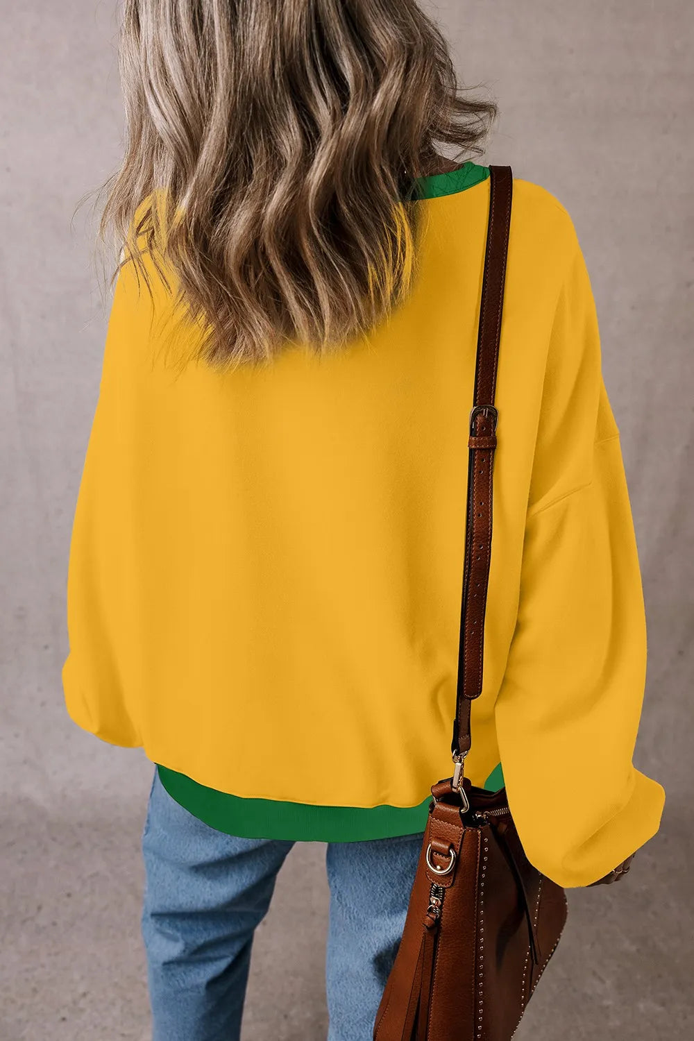 Yellow long-sleeve sweatshirt with green contrast hem band and round neck collar