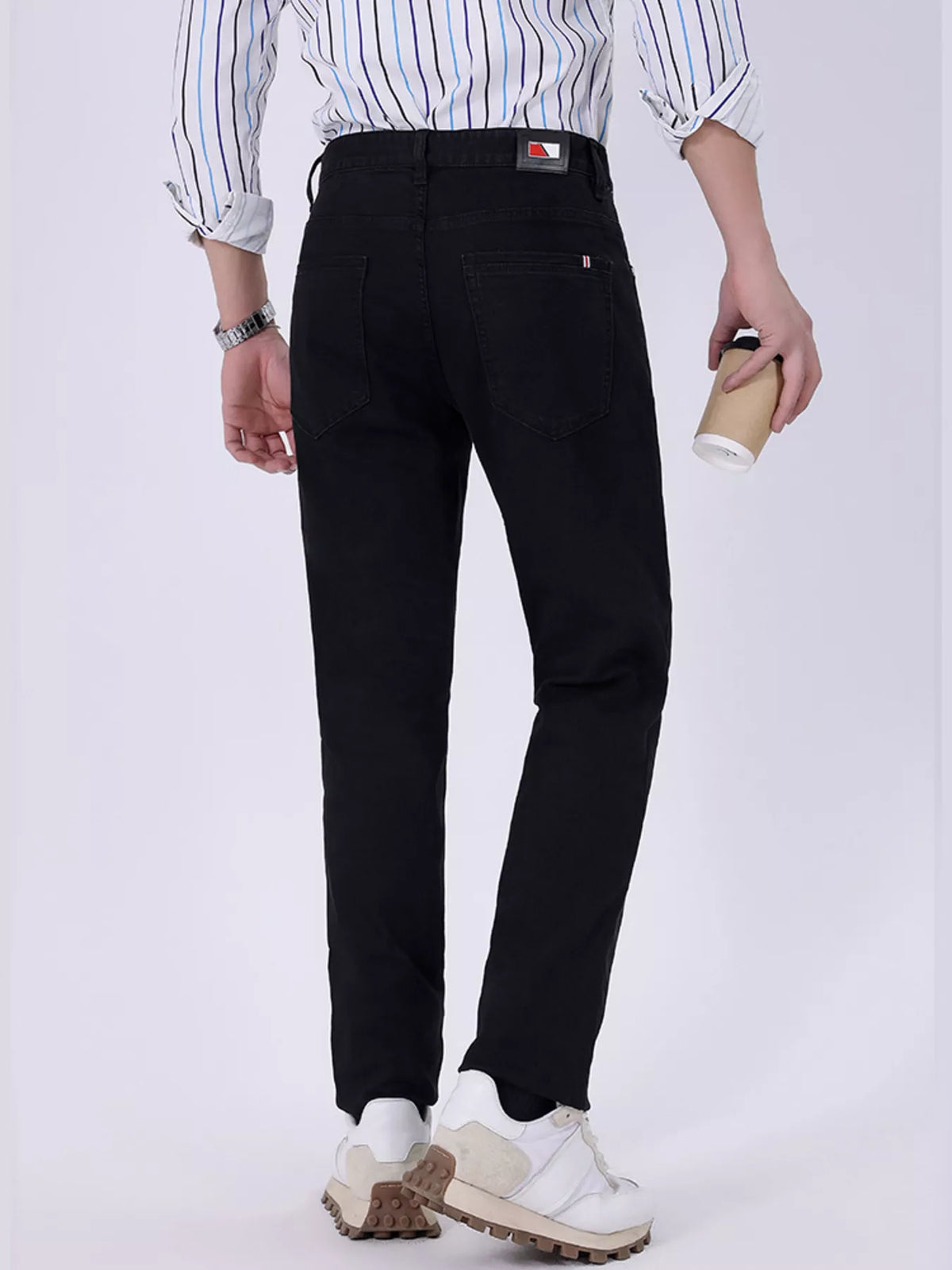 Black slim-fit jeans with rear welt pockets and stitched back seams