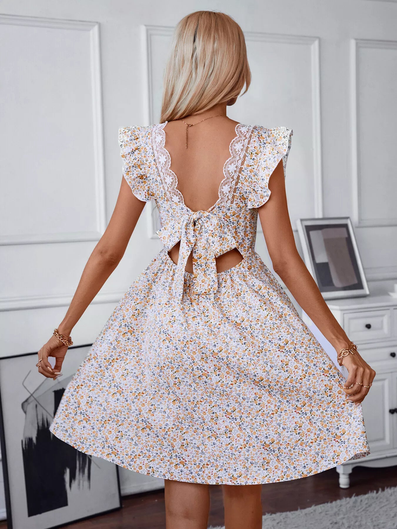 Floral mini dress in white with lace-trimmed open back and tie-back bow, puff sleeves