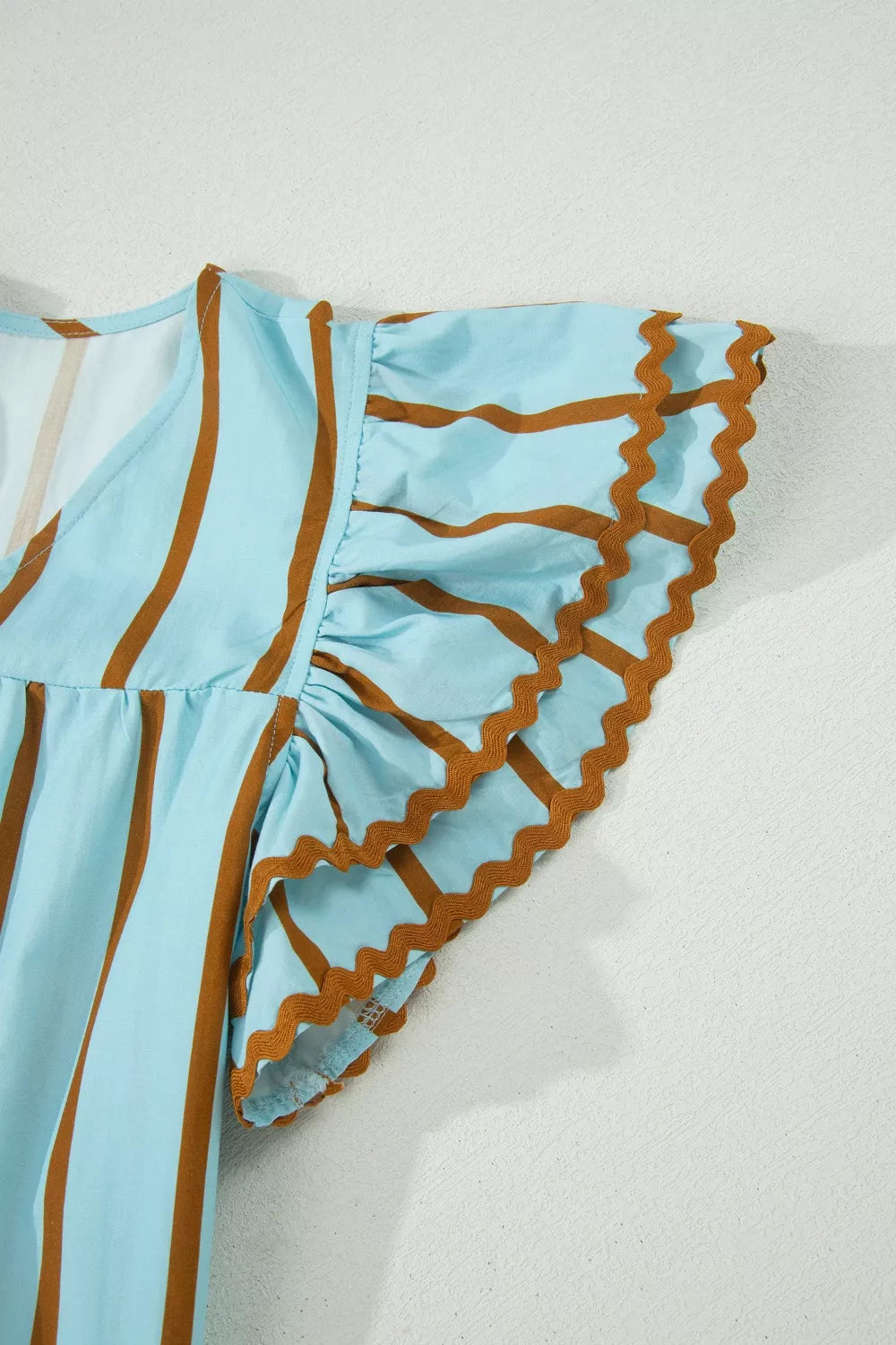 Cedar & Moore Stripe ricrac trim double-ruffle short sleeve V-neck blouse in light blue with brown accents by Trendsi