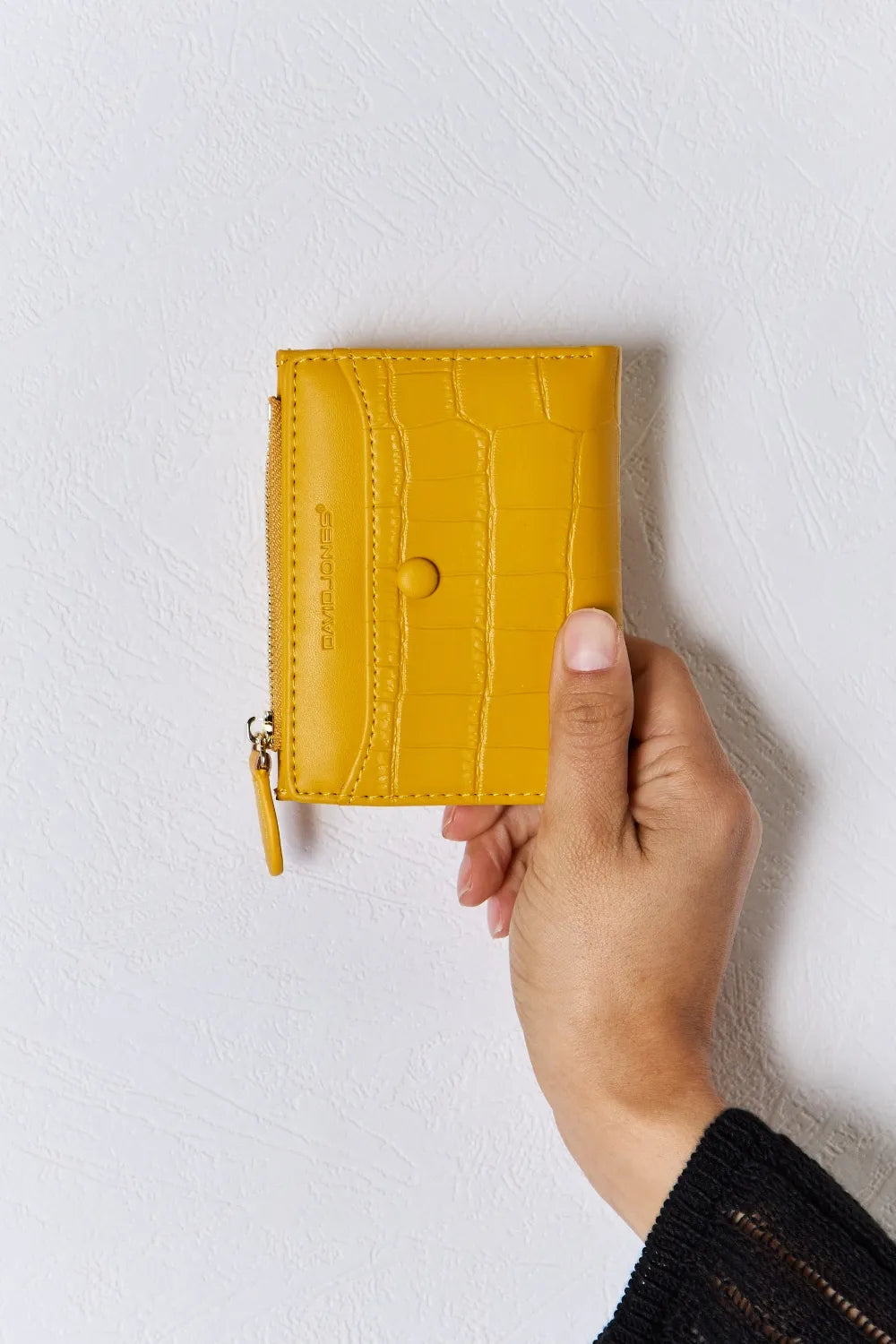 Yellow textured vegan leather mini wallet with front logo and zip pull tab