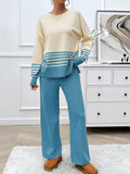 Two-piece sweater set with cream top, blue striped hem and cuffs, and teal wide-leg pants.