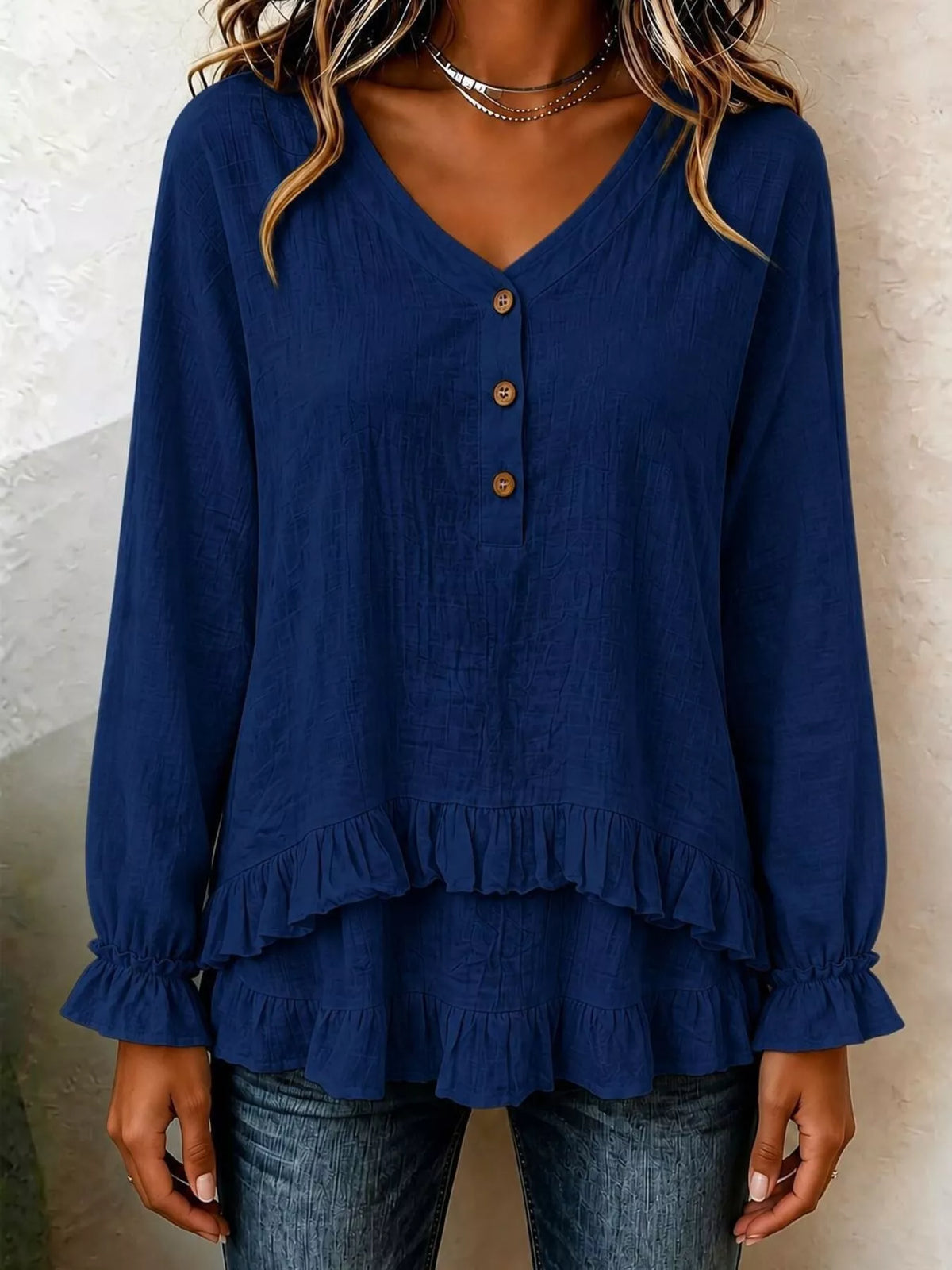 Navy V-neck long-sleeve blouse with button placket and tiered ruffled hem