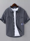 Navy and white plaid short-sleeve cotton button-up shirt with chest pockets and front buttons