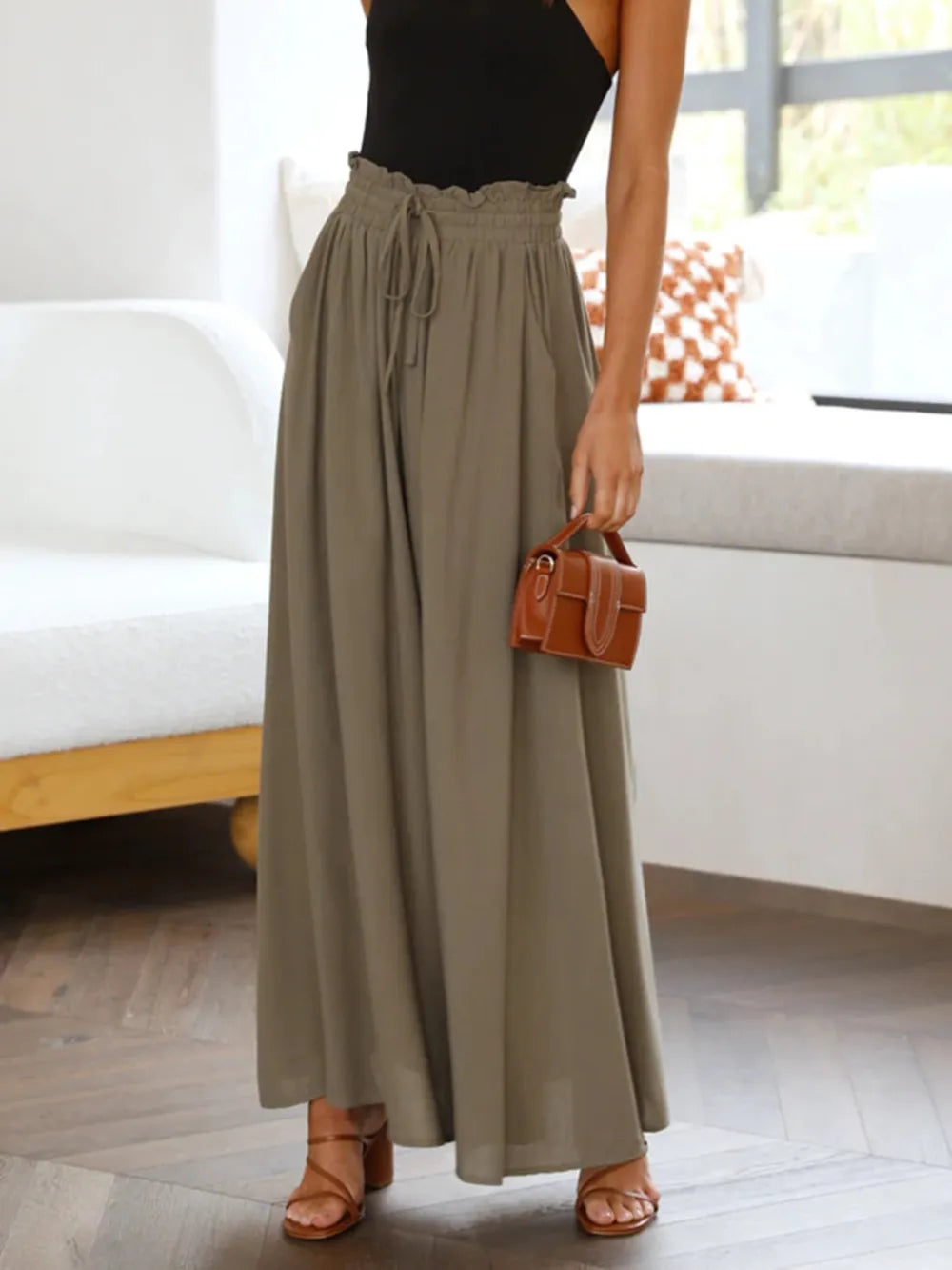 Olive wide-leg pants with elastic drawstring waist and side pockets, standing view
