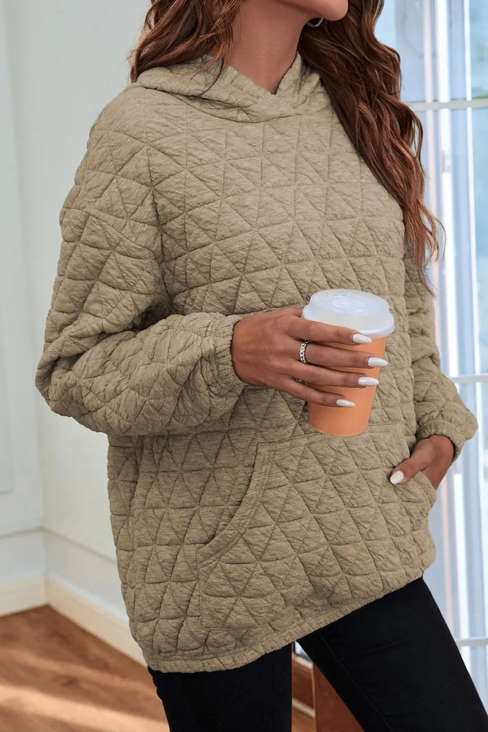 Khaki quilted long-sleeve hoodie with hood and front pocket, front view