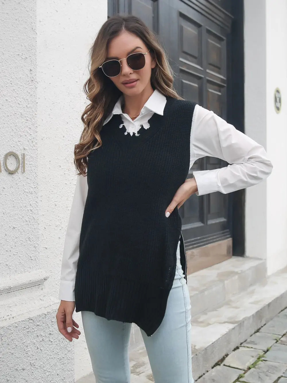 Black knit sweater vest with frayed slit hem and white shirt collar