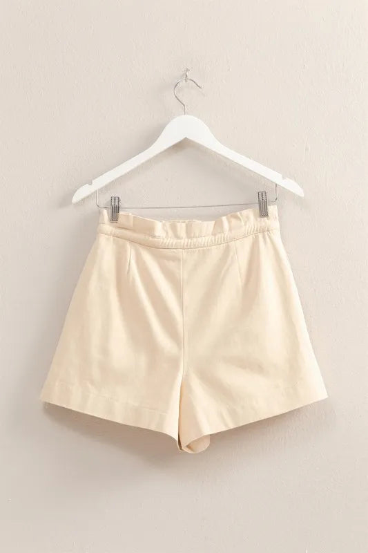 Oatmeal high-waisted paperbag shorts on hanger, elastic waistband with drawstring tie