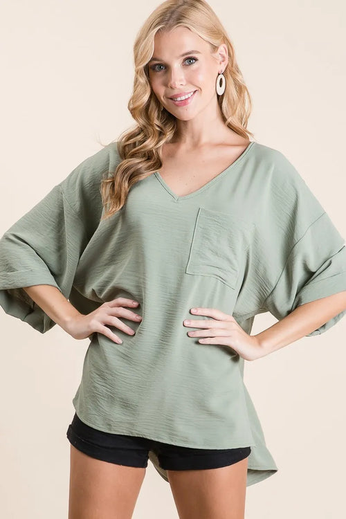 Sage woven V-neck tunic top with front pocket and wide sleeves, rolled cuffs