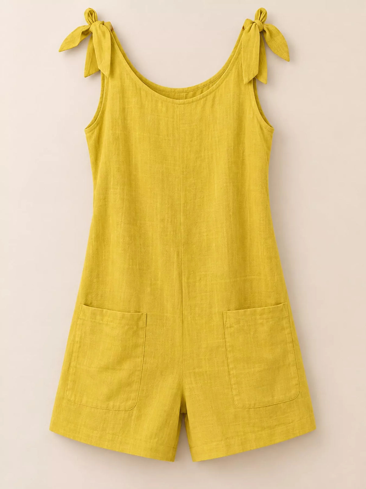 Yellow tie-shoulder bow romper with pockets, wide leg shorts, and sleeveless scoop neck