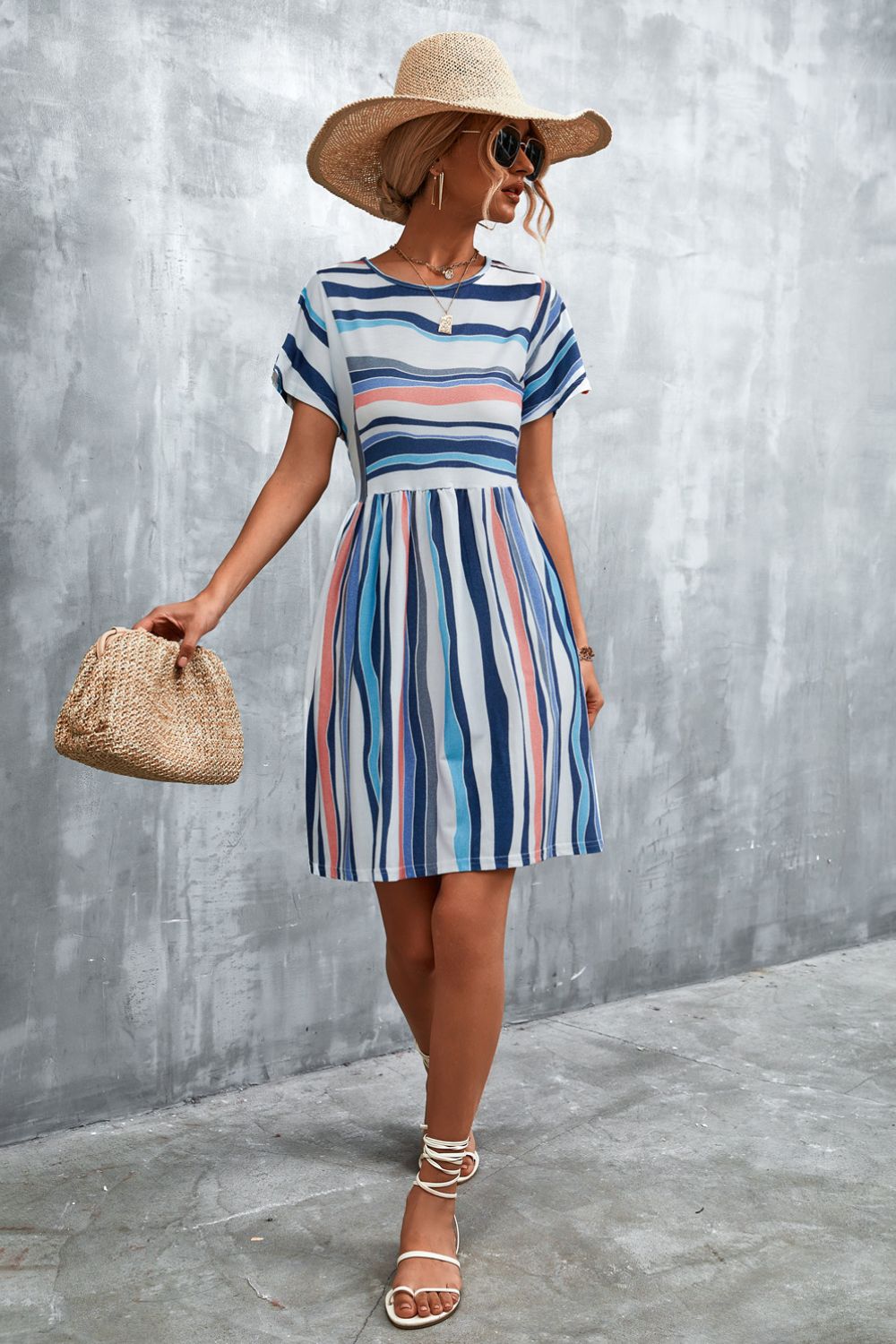 Striped round-neck dress with short sleeves, blue vertical stripes and gathered skirt, above-knee hem