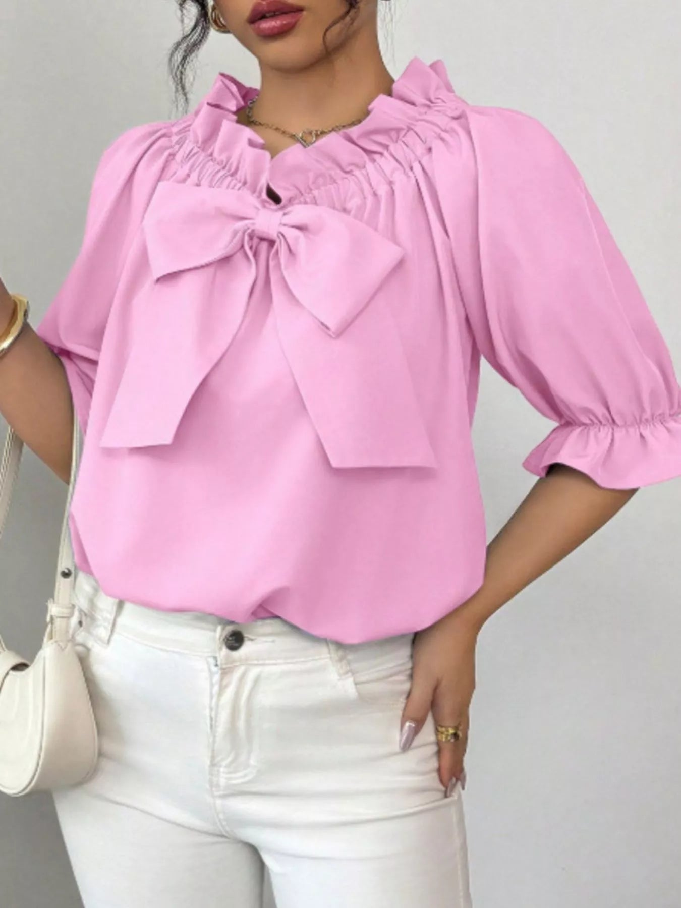 Bow Flounce Sleeve Blouse in pink with a large front bow, ruffled neckline and puff sleeves.