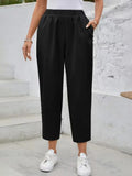 Black high-rise elastic waist pants with tapered cropped legs