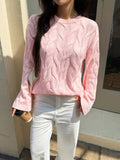 Pink cable knit long sleeve sweater with round neckline and raised cable pattern