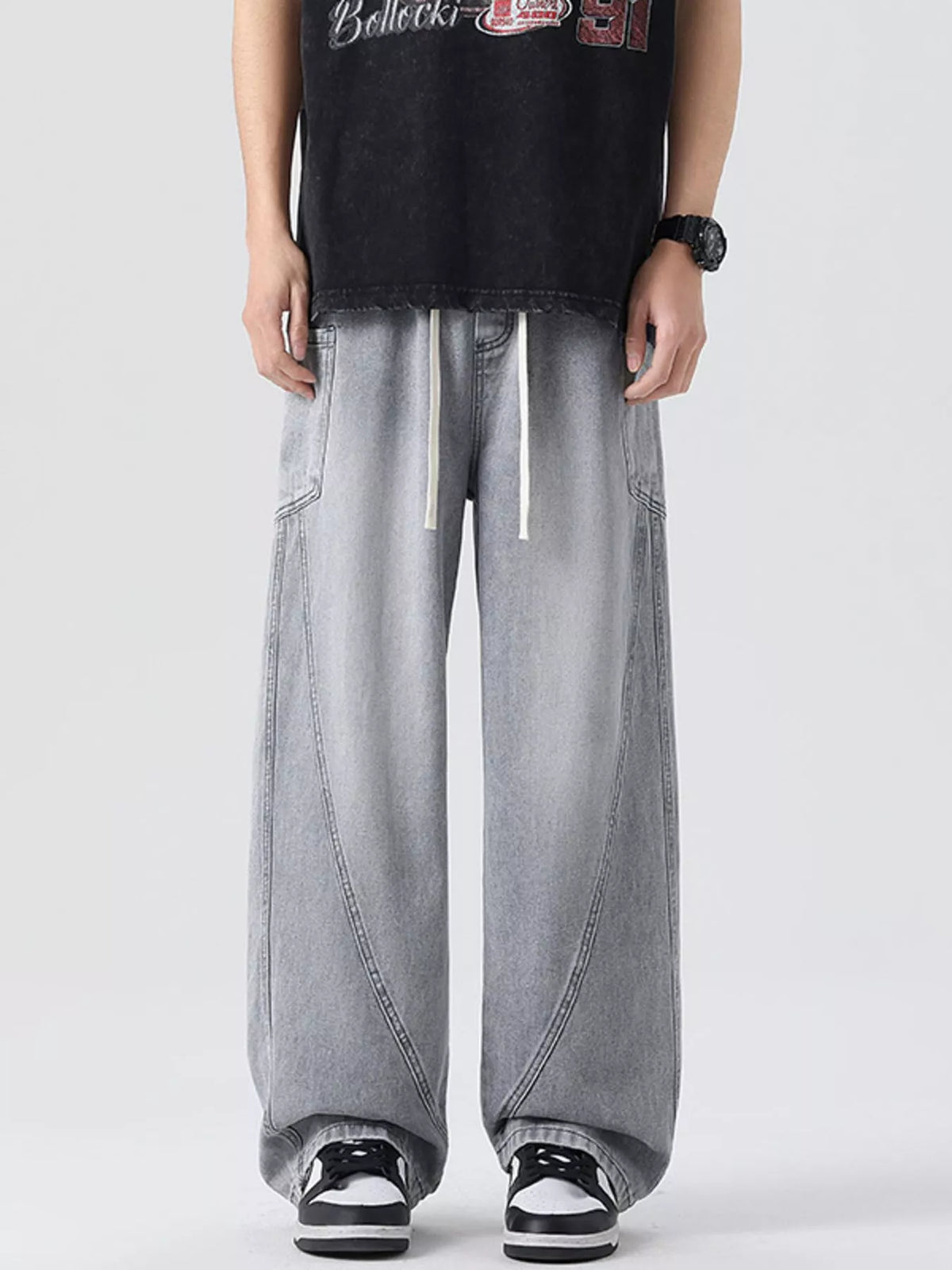 Men's vintage wide-leg jeans in light gray denim with drawstring waist, relaxed legs.