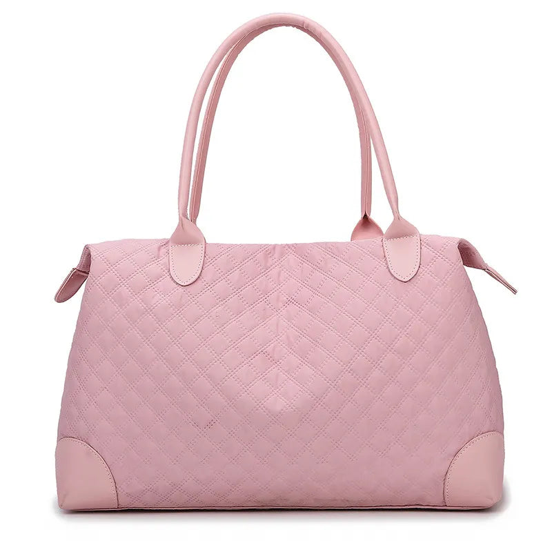 Dusty pink quilted duffel-style travel bag with top handles and zip closure