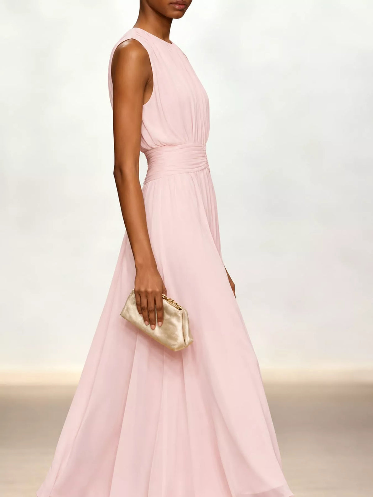 Pink sleeveless chiffon maxi dress with ruched waist and layered, flowing skirt