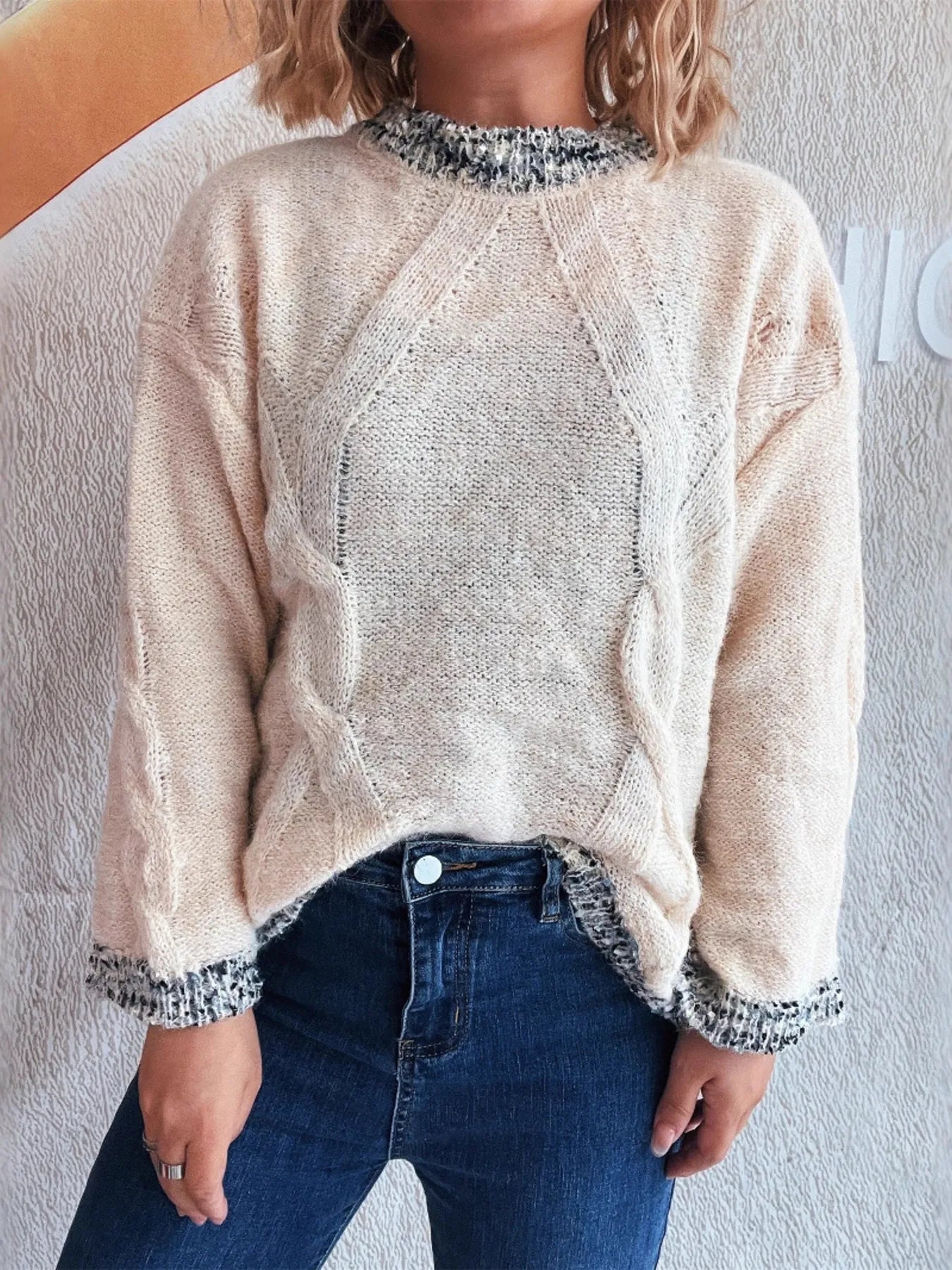 Apricot round-neck sweater with contrast collar trim and textured hem