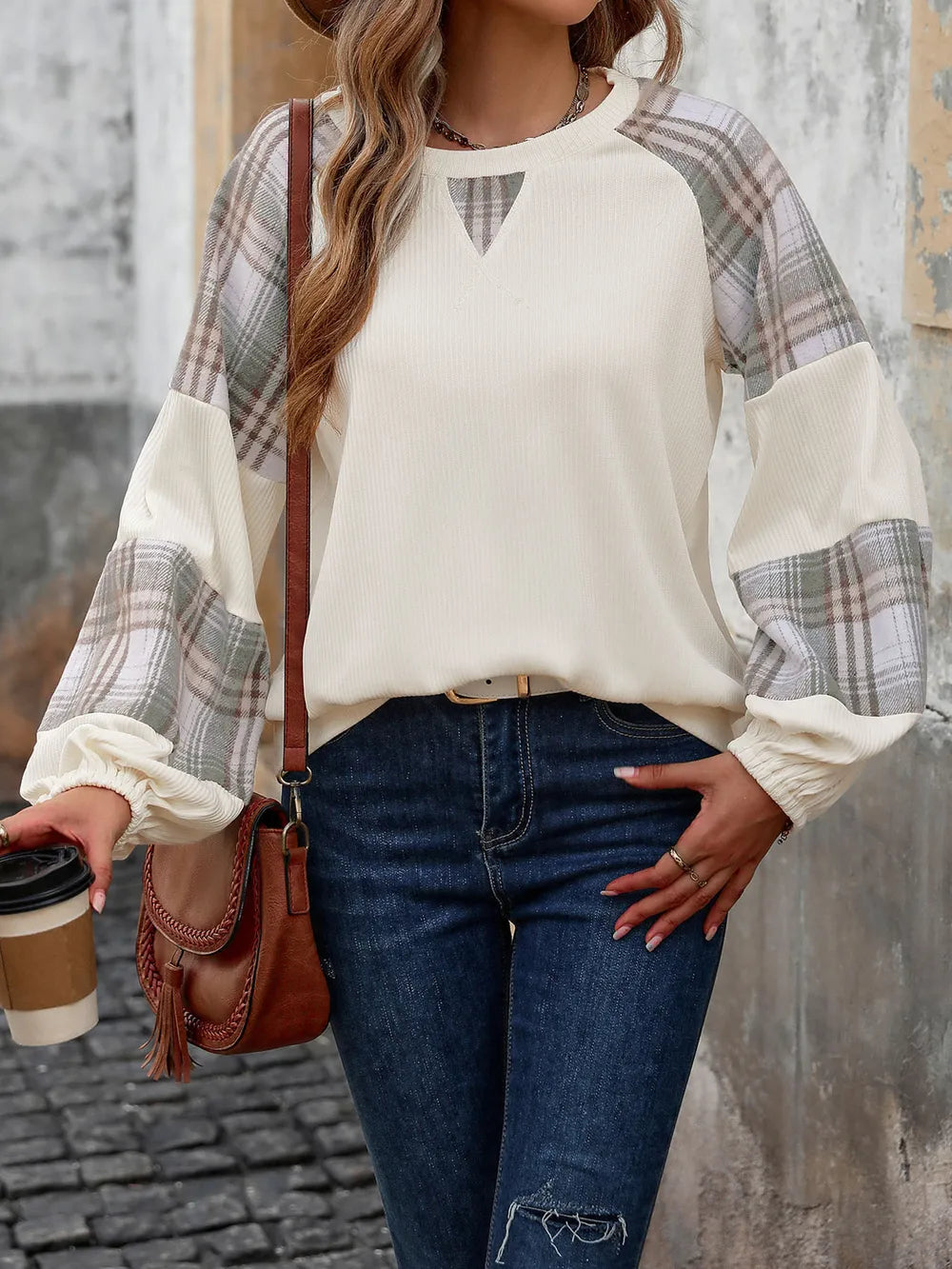 Cream sweatshirt with plaid raglan sleeves and keyhole neckline, loose fit