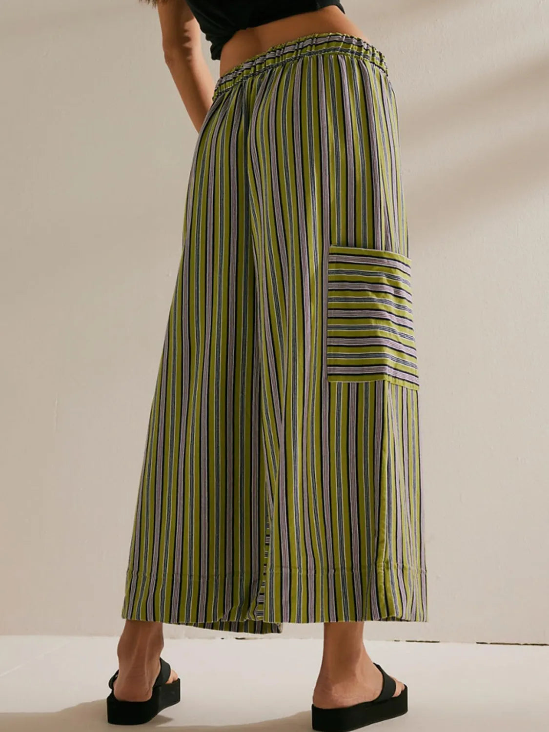 Moss green vertical striped wide-leg pants with elastic waist and contrast pocket panel