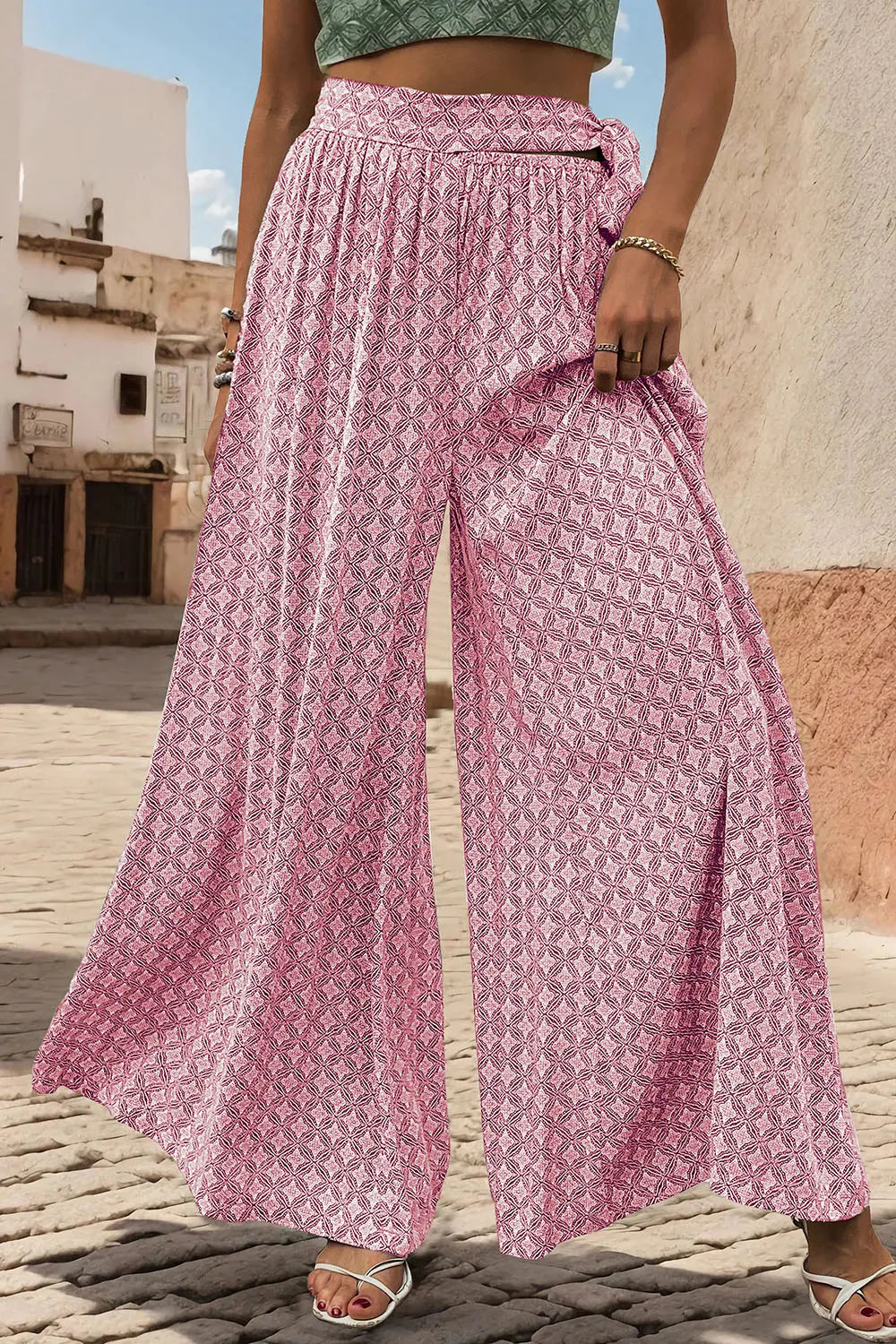 Pink printed wide-leg pants with gathered waist tie and full, flowy leg shape